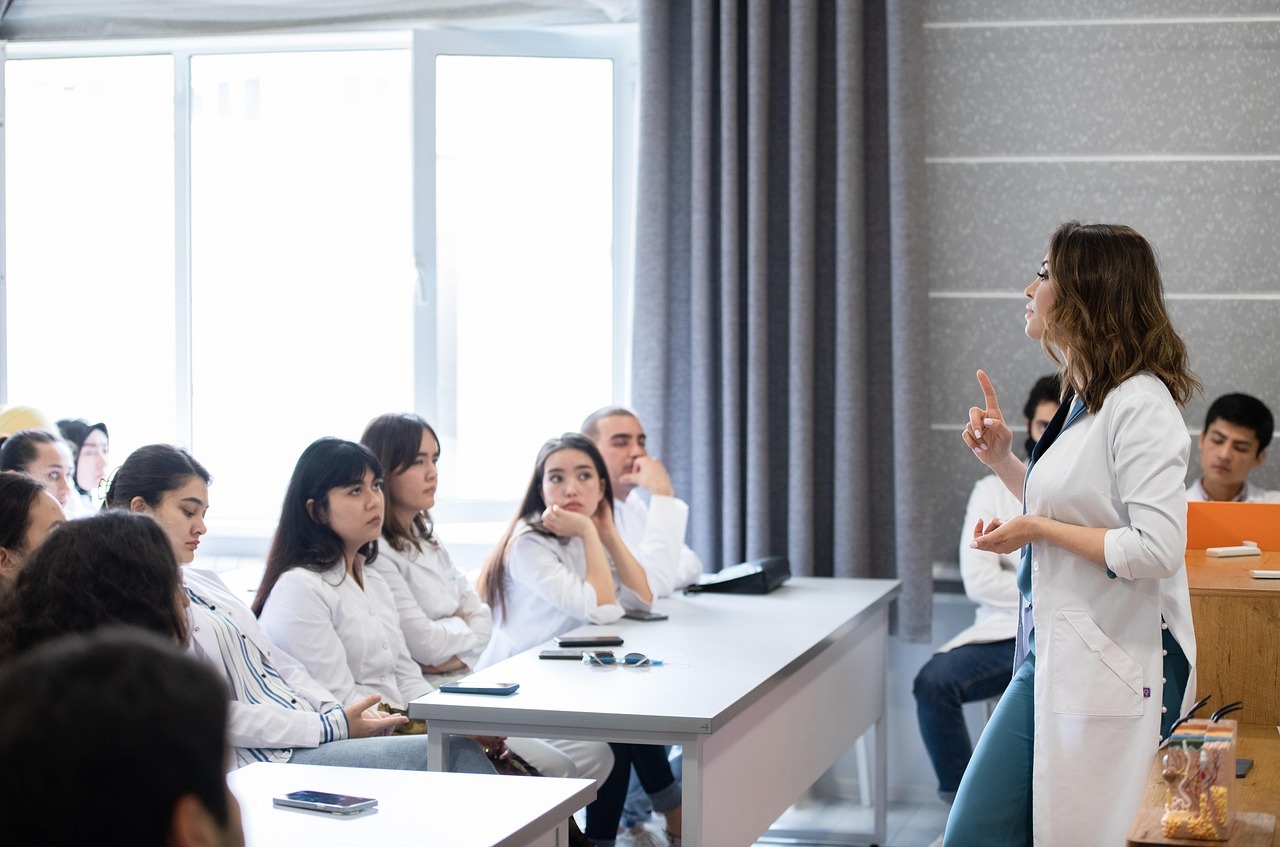 Medical student lecture, with a doctor teaching a group of students in a classroom as part of a pre-med education program